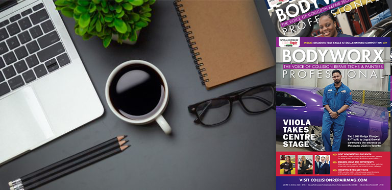Workspace desk with laptop, coffee, notebook, glasses, and BodyWorx Professional magazine cover featuring Viola