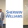 Two professional men in business casual attire standing before Sherwin-Williams branded backdrop with paint can logo
