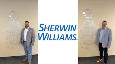 Two professional men in business casual attire standing before Sherwin-Williams branded backdrop with paint can logo