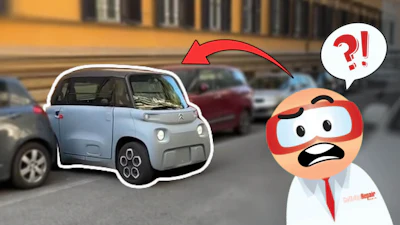 Confused cartoon mechanic pointing at a light blue Citroën Ami car parked on a city street
