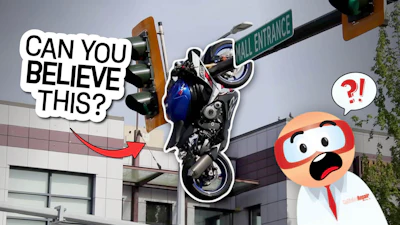 Motorcycle stunt performer doing wheelie near mall entrance with animated character reacting in surprise