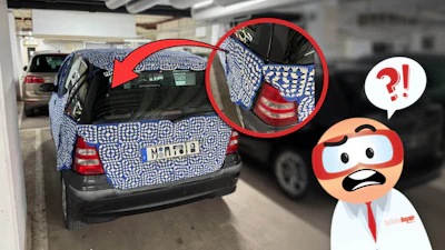 Blue and white patterned car wrap in parking garage with highlighted details and confused character reaction