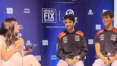 Two racing drivers being interviewed at Réseau FIX Network event with female host holding microphone