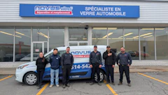 Novus Tires team posing in front of storefront with branded service vehicle