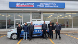 Novus Tires team posing in front of storefront with branded service vehicle