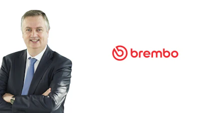 Professional male executive in dark suit and blue tie with Brembo logo