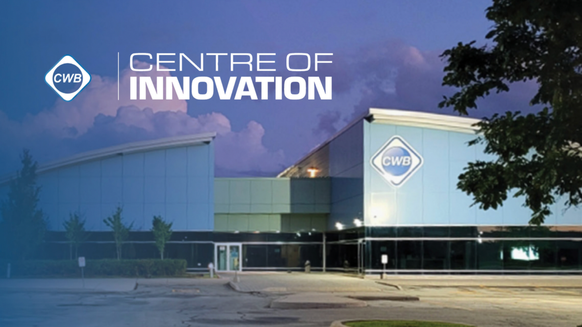 CWB Centre of Innovation modern facility at twilight with illuminated signage and landscaping