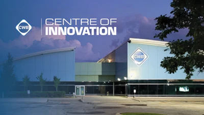 CWB Centre of Innovation modern facility at twilight with illuminated signage and landscaping
