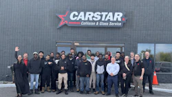 CARSTAR Collision & Glass Service team photo with employees standing outside facility entrance