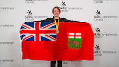Young woman holding Ontario flag and wearing gold medal at Skills/Compétences Canada competition event