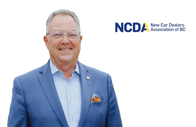 Professional headshot of man in blue blazer and striped shirt with NCDA New Car Dealers Association of BC logo