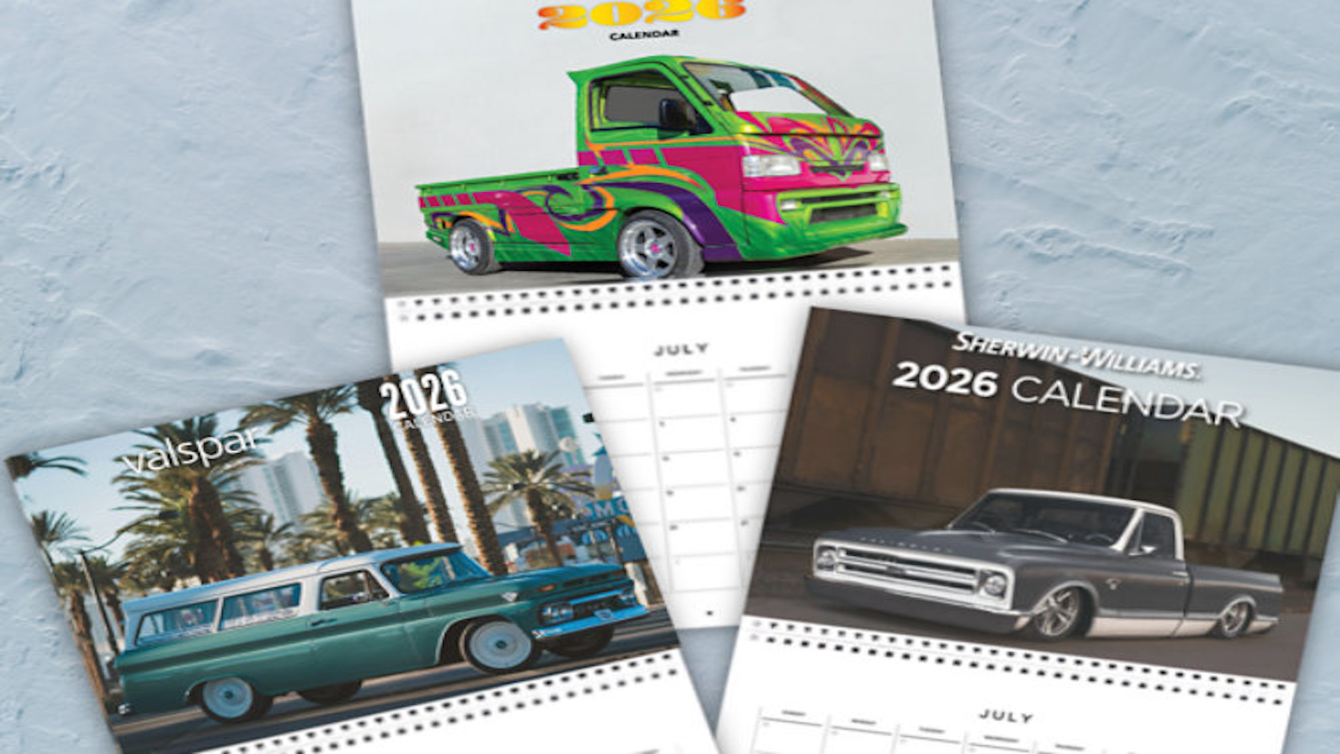 Collection of 2026 car-themed calendars featuring colorful custom vehicles and classic trucks on white background
