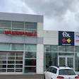 Commercial storefront with Fix Collision and Novus Glass signage on modern building facade