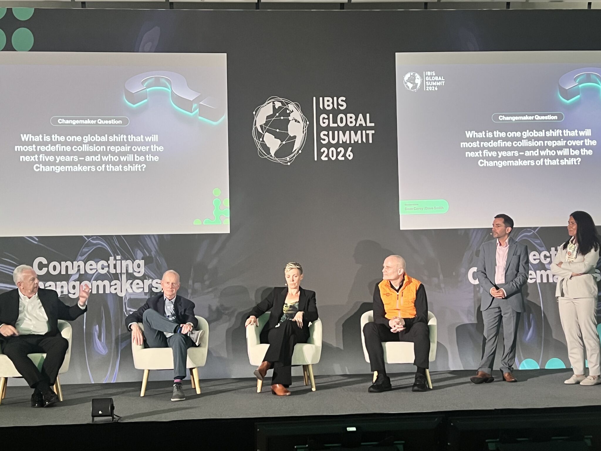 IBIS Global Summit 2024 panel discussion with five speakers seated on stage discussing changemakers in collision repair industry