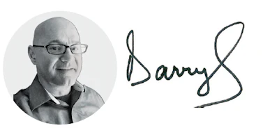 Professional headshot of bald man wearing glasses and dark jacket alongside handwritten signature reading Barry S