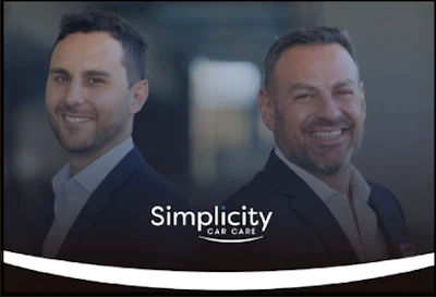 Two professional men in business suits smiling at camera with Simplicity Care logo and curved white accent bar