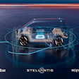 Autonomous vehicle concept with transparent chassis showing internal technology, displayed with Uber, Stellantis, and Wayve partnership branding
