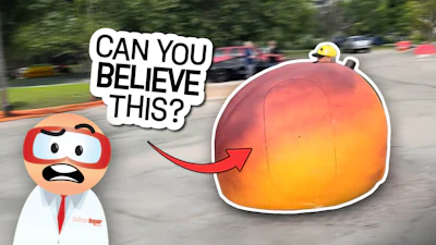 Cartoon character expressing shock with speech bubble pointing to oversized orange balloon on go-kart track