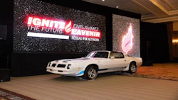 White Pontiac Firebird sports car on display at IGNITE corporate event with illuminated branded signage