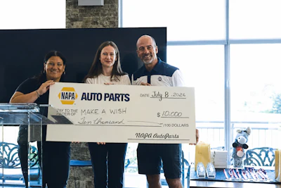 Three people holding a $10,000 NAPA Auto Parts donation check for Make a Wish Foundation on July 8, 2026