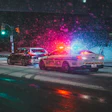 Police car with flashing red and blue lights responding at night on a wet street with colorful light effects