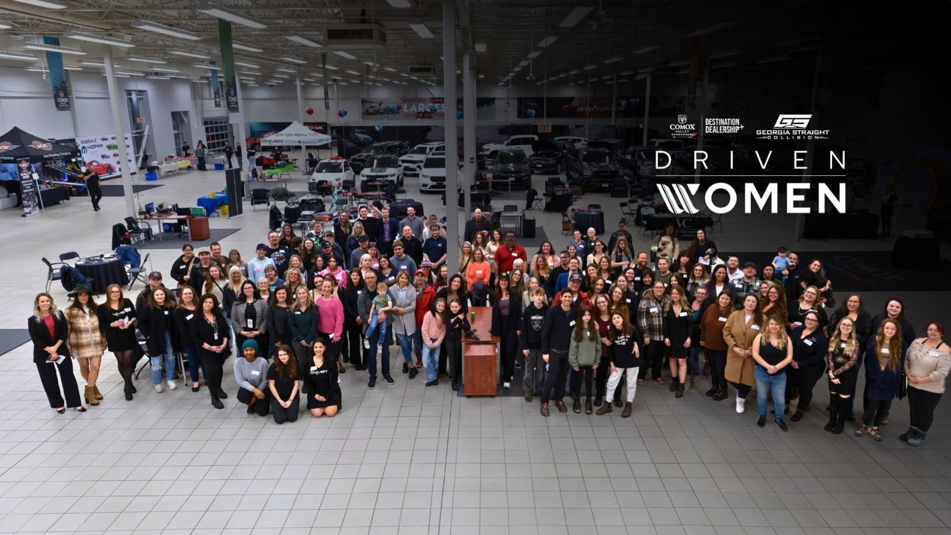 Large diverse group of women gathered in warehouse setting for Driven Women initiative event