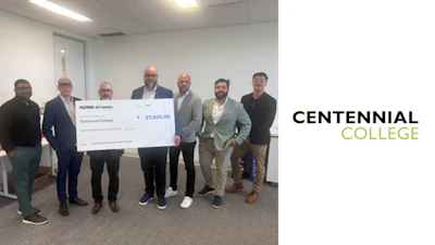 Seven men in business attire hold a ceremonial check for $27,500 donation to Centennial College in an office setting