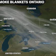 NASA satellite image showing wildfire smoke blankets across Ontario and Quebec on July 14, 2025, with active fire locations marked in orange.