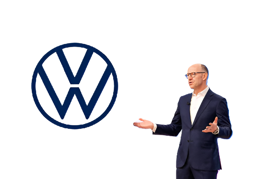 Businessman in navy suit presenting Volkswagen logo during corporate presentation