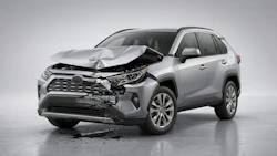 Silver Toyota RAV4 SUV with severe front-end collision damage and deployed airbags