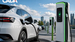 White electric vehicle charging at green and white EV charging stations with city skyline in background
