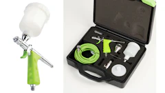 Professional airbrush spray gun kit with green hose, paint cups, and accessories in black carrying case