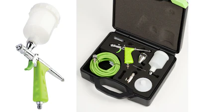 Professional airbrush spray gun kit with green hose, paint cups, and accessories in black carrying case