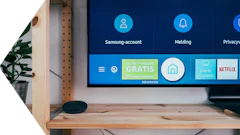 Samsung Smart TV home screen displaying account settings, apps, and services including Netflix and live TV options