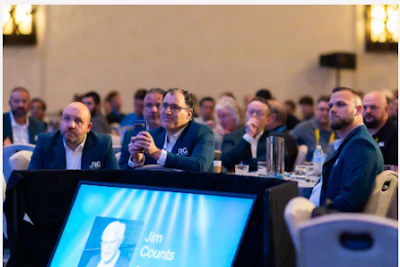 Corporate panel discussion with professionals seated at table during business conference event