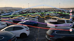Aerial view of car lot with rows of vehicles and colored overlay lines indicating routes or inventory organization