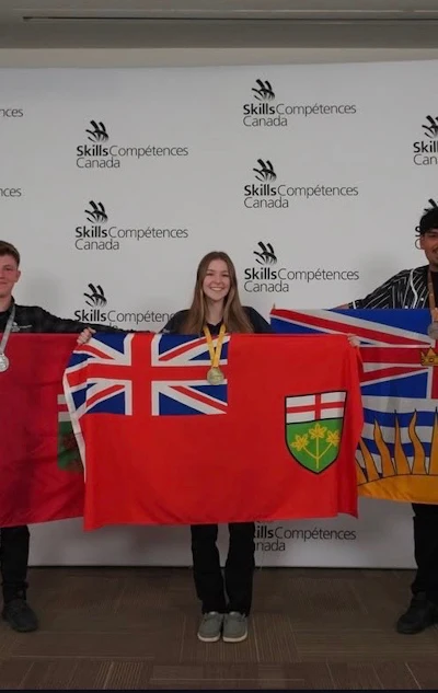 Three people holding Canadian provincial flags at Skills/Compétences Canada event