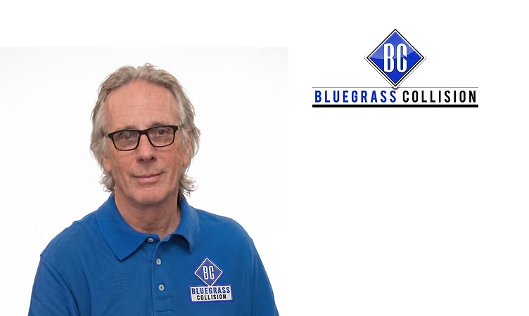 Professional man in blue Bluegrass Collision polo shirt wearing glasses