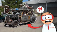 Rusty modified vehicle with cartoon character mascot expressing shock in industrial setting