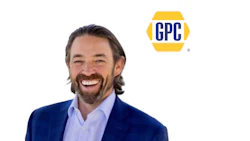 Professional man in navy blazer and light blue shirt smiling next to GPC logo
