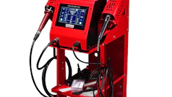 Red industrial welding machine with digital control panel, gas cylinder, and dual welding torches on wheeled cart