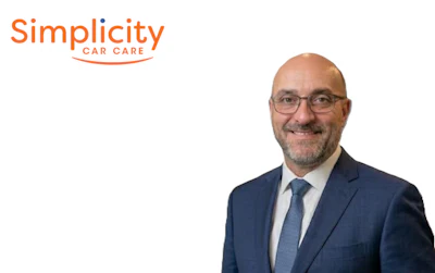 Professional headshot of a man in blue suit with Simplicity Car Care logo