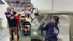Volunteers restoring a vintage car at an indoor workshop event, with team members working on vehicle body panels and doors.