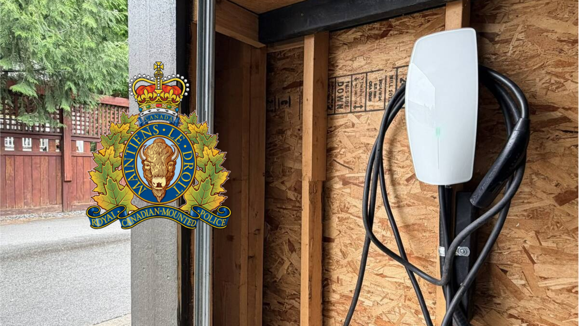 RCMP official crest mounted on wooden door frame with charging station visible
