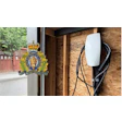 RCMP official crest mounted on wooden door frame with charging station visible