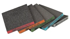 Assorted sandpaper sheets fanned in display showing different grit levels with colored edge labels