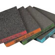 Assorted sandpaper sheets fanned in display showing different grit levels with colored edge labels