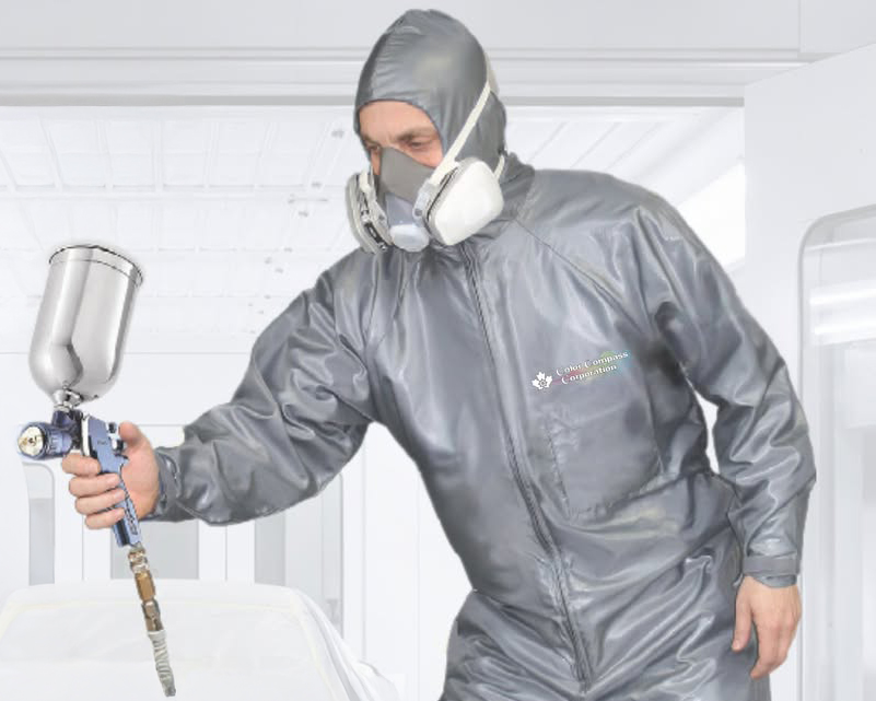 Professional painter wearing gray protective suit, hood, and respirator mask while holding spray gun equipment