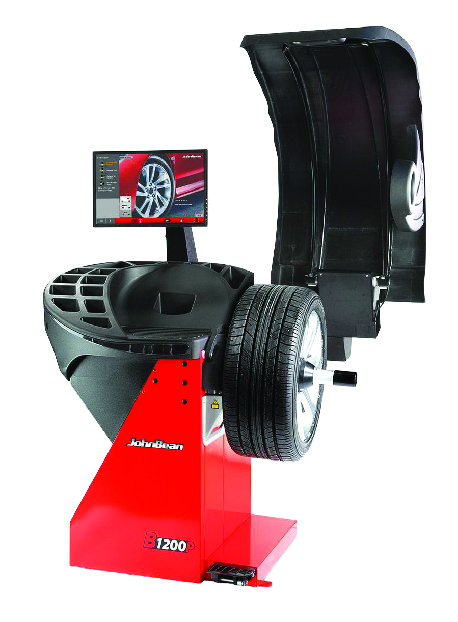 JBT B1200 wheel balancer with digital display monitor and mounted tire assembly