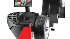 JBT B1200 wheel balancer with digital display monitor and mounted tire assembly